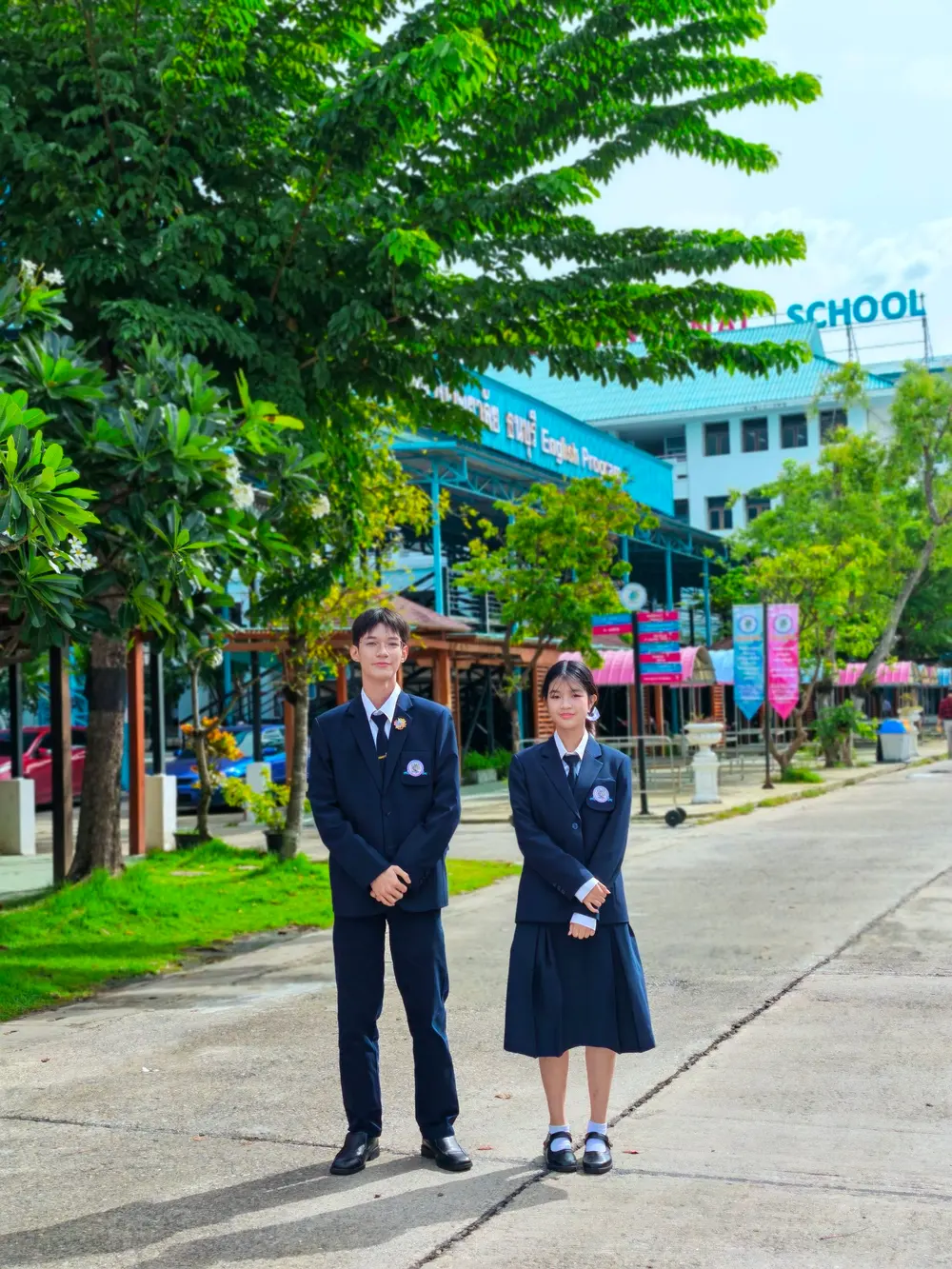 Two SKT students in uniform on campus
